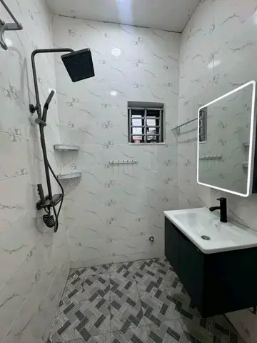 White marble bathroom with charcoal vanity — 1