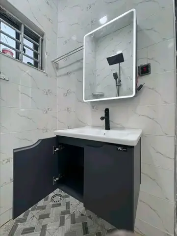 White marble bathroom with charcoal vanity — 4