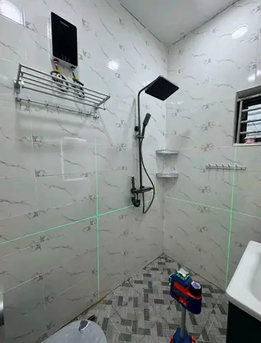 White marble bathroom with charcoal vanity — 5